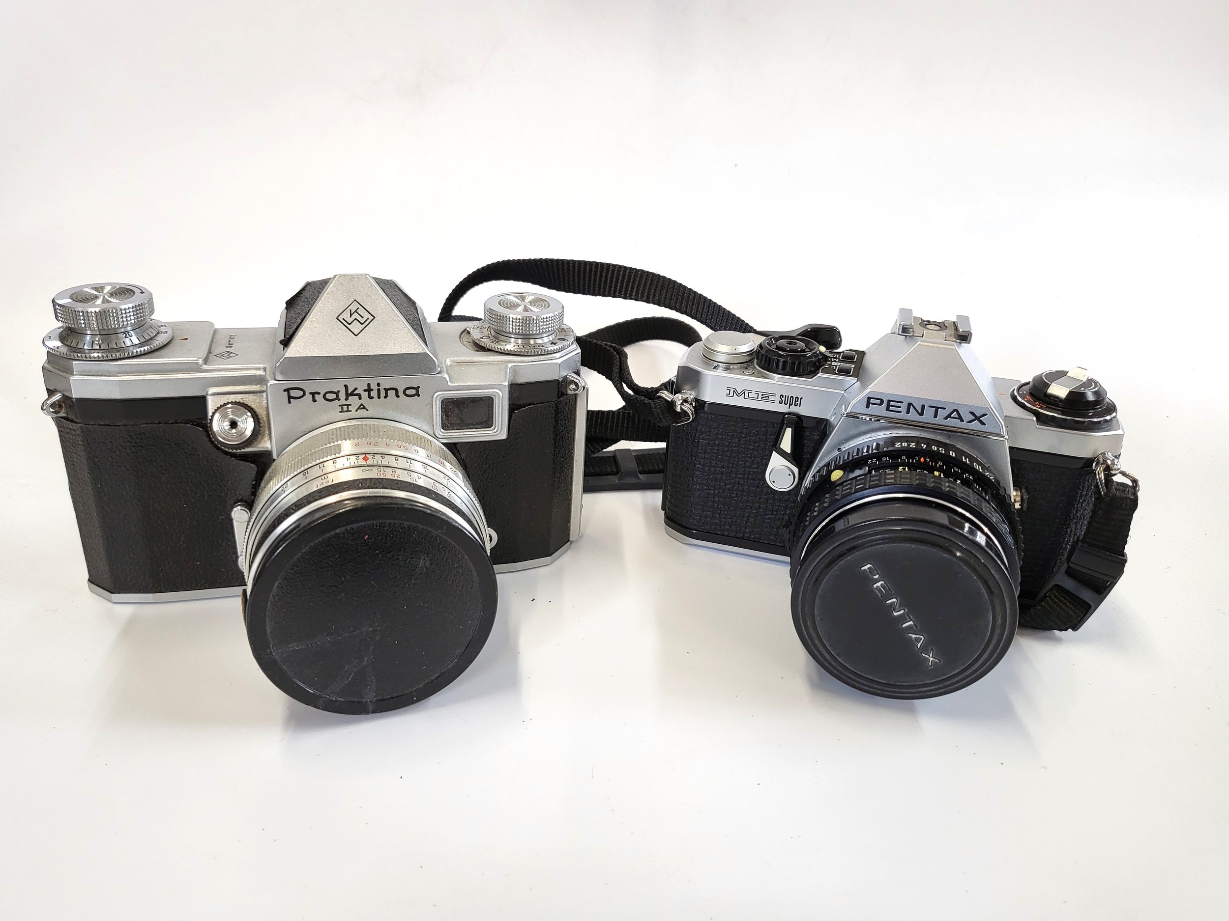 Three SLR cameras, Pentax ME Super and a Praktina, a Z008 digital camera, and an Olympus Trip. A - Image 3 of 8