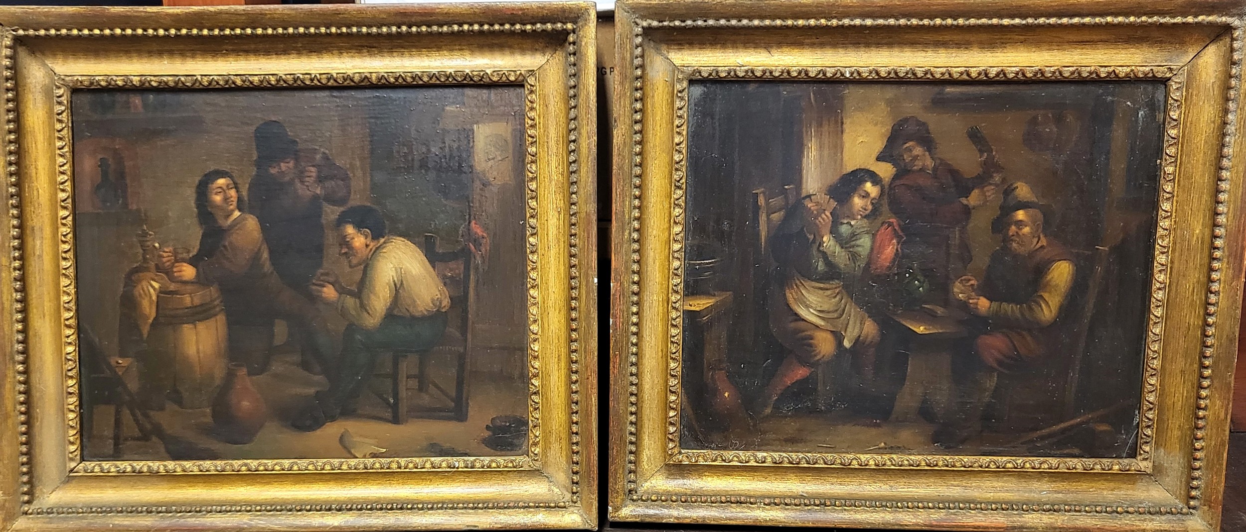 A pair of late 19th century paintings depicting tavern interior scenes, oil on board, in giltwood