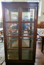 A wooden and glass display cabinet, two doors. 174cm x 89cm x 42cm.