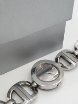 A Christian Dior white metal watch, the mirrored dial with 12 and baton markers, on chunky D-link