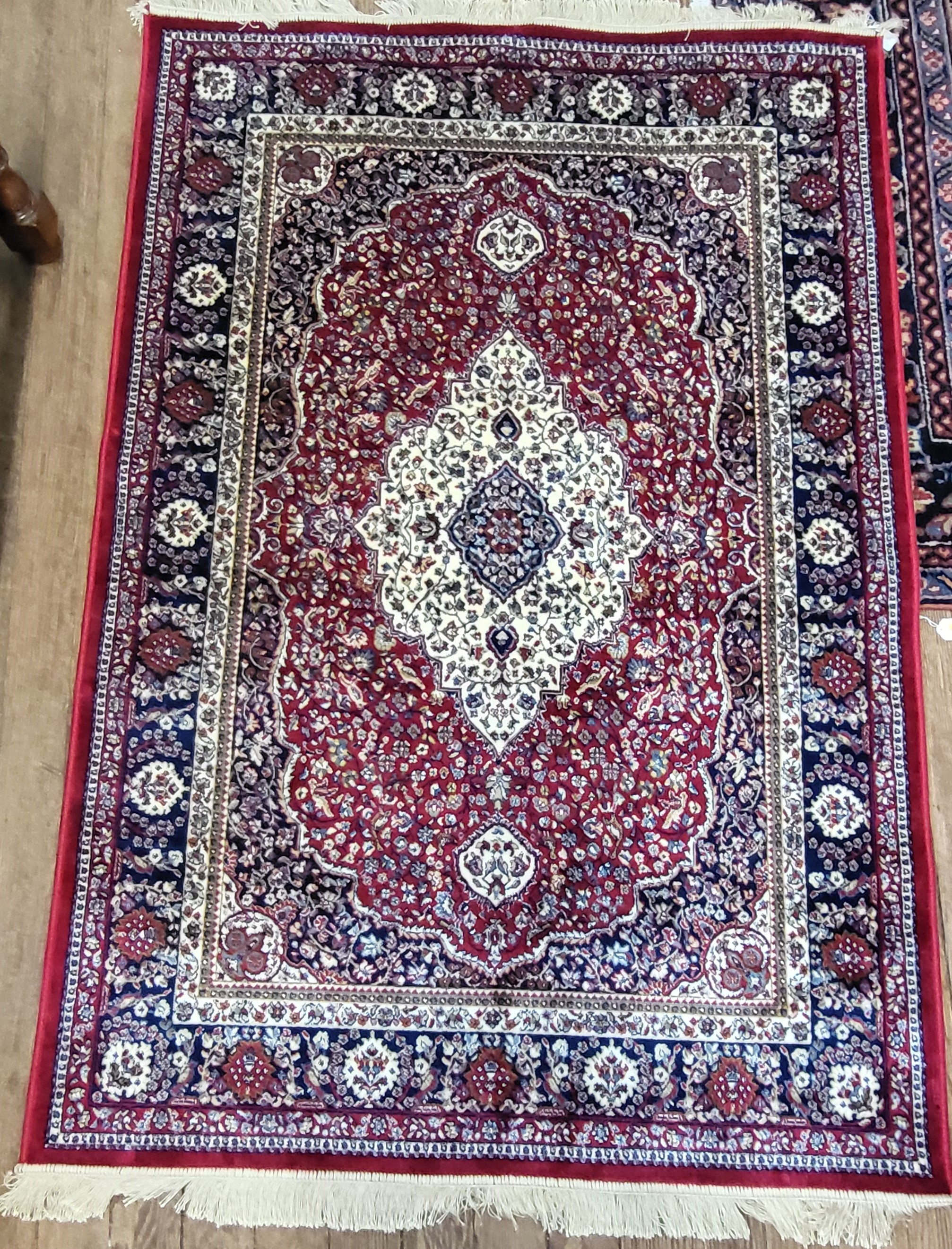 A fine Persian rug, central medallion design, blue, red and cream ground, bordered and