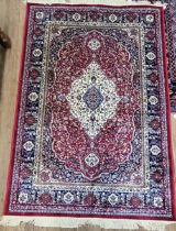 A fine Persian rug, central medallion design, blue, red and cream ground, bordered and
