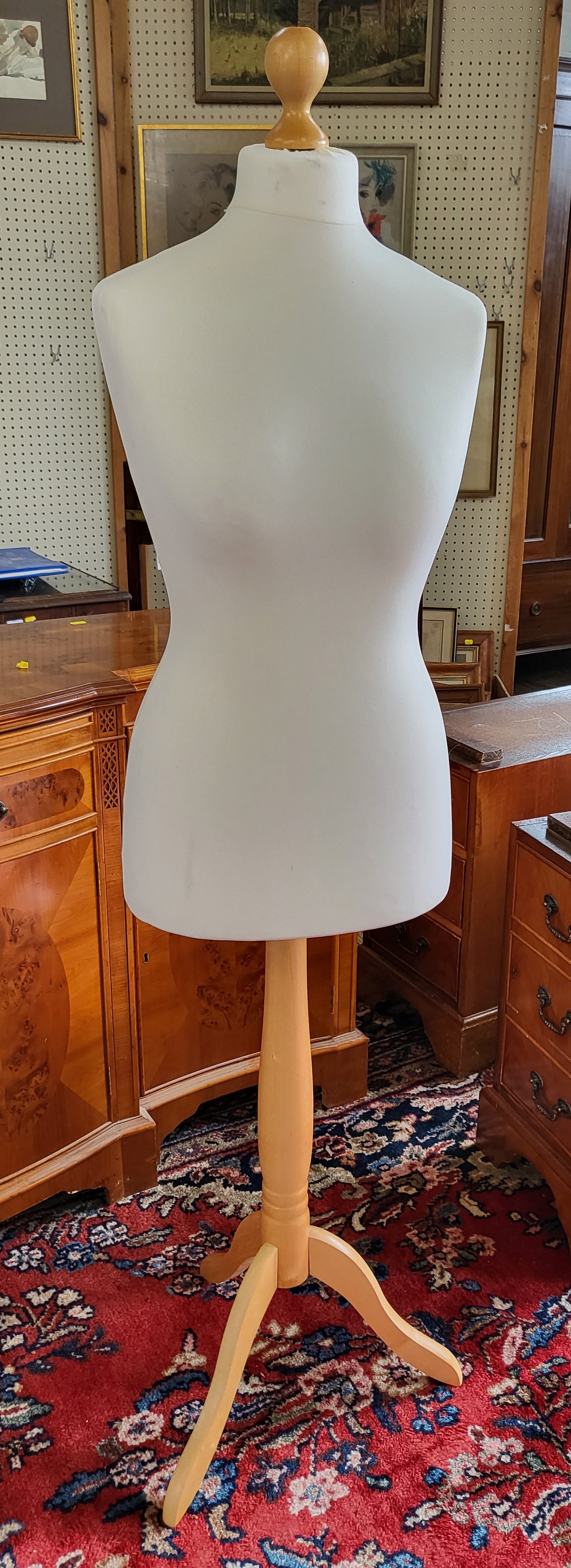 A tailor's dummy, fabric-covered body supported on pine tripod stand.