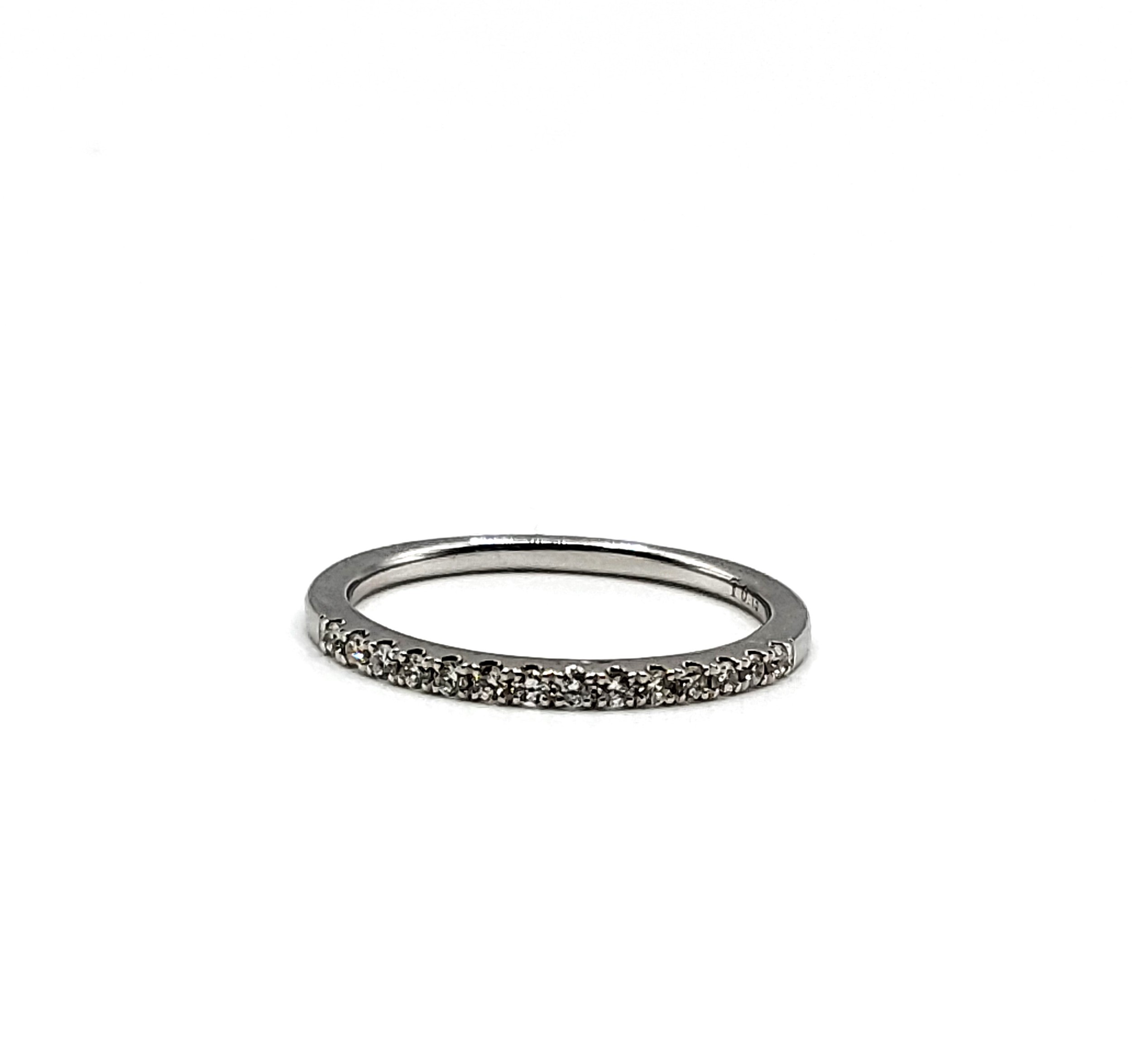 An 18ct white gold and diamond band ring, inset with round brilliant-cut diamonds, size L 1/2. (