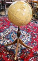 A vintage Cram's Imperial world globe with meridian ring on a turned baluster support, with four out
