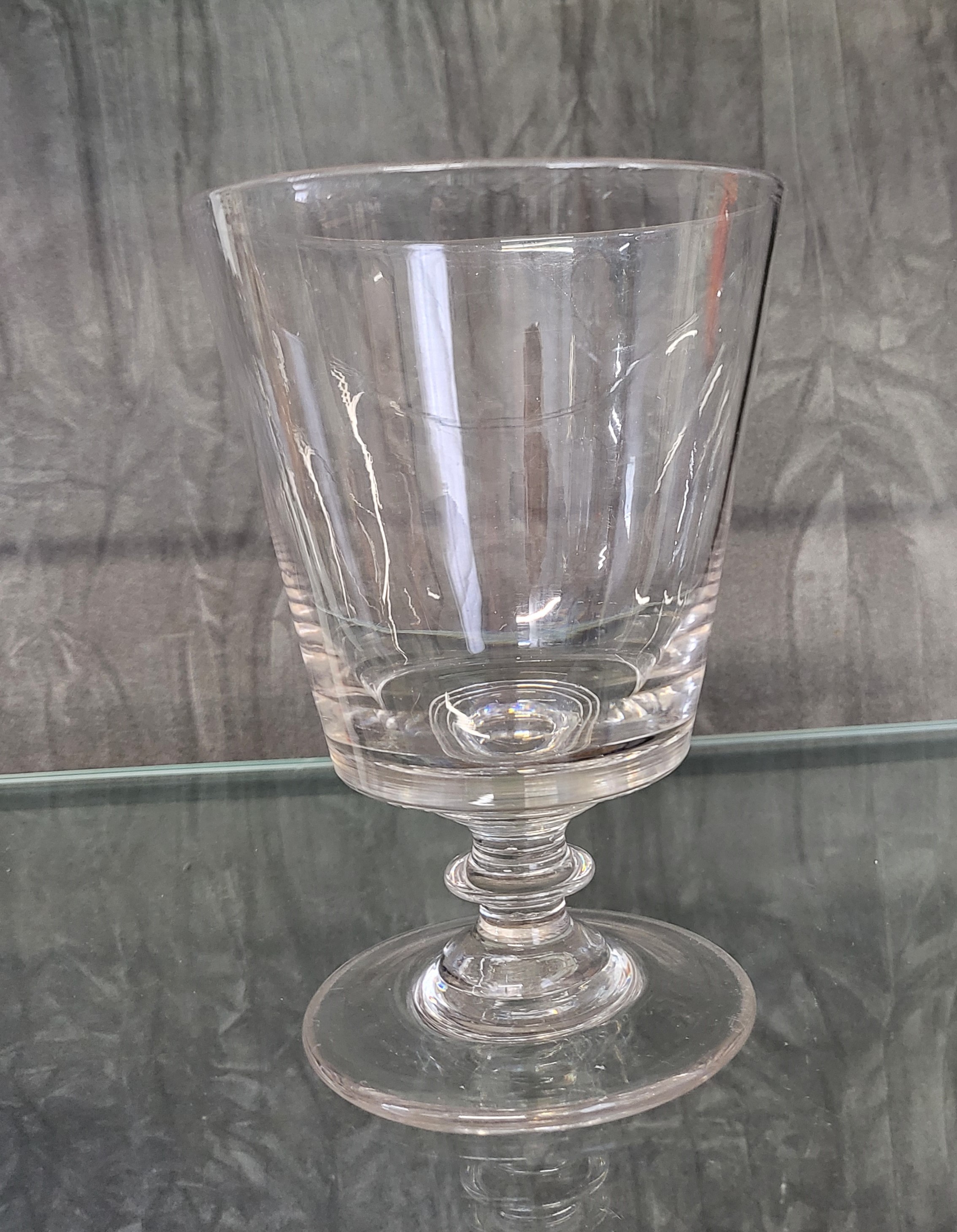 An early 19th century large glass rummer with bucket bowl, bladed knop stem and unground pontil,