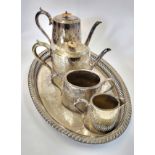 A collection of silver-plate including a tray, a coffee pot, a tea pot,a sugar bowl and cream
