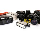 Four Canon cameras: A canon AV-1 35mm camera with case, strap and Canon FD 135mm 1:3.5 lens, a Canon