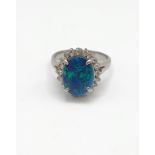 A platinum, diamond, and black opal doublet ring, the opal measuring approximately 12.4 x 9.5 mm,