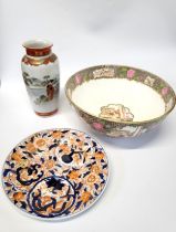 A Japanese Imari plate, 21.5cm diameter, a Kutani vase, 20cm, and a famille-rose bowl, 27cm. (3)