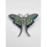 A silver and plique a jour pendant brooch, in the form of a butterfly, decorated with blue and green