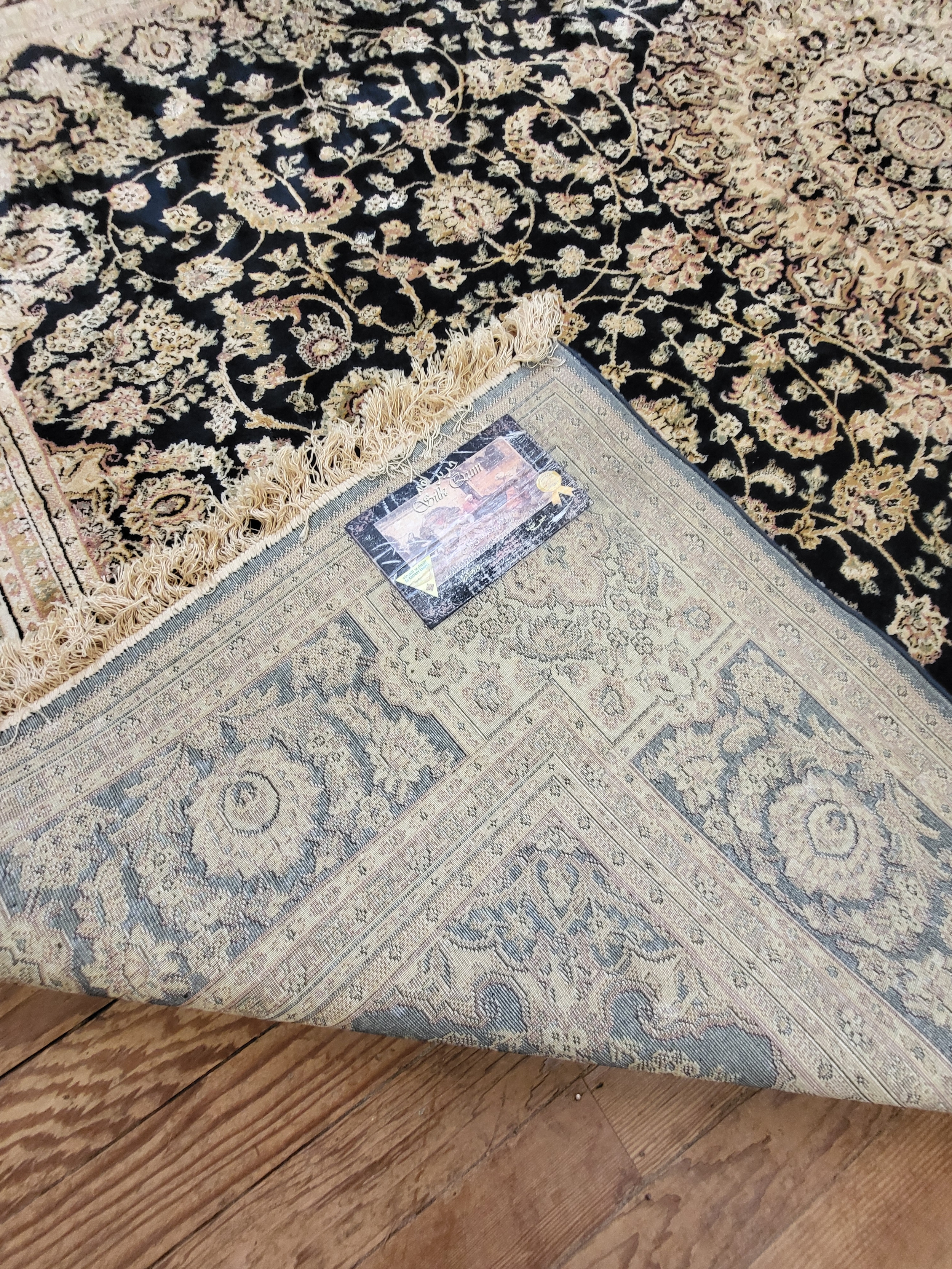 A large cream and black ground rug, with central medallion on elaborate decoration, bordered and - Image 2 of 2