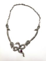 A silver and marcasite necklace, of twisted serpent design, the snakes set with ruby cabachons.