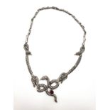 A silver and marcasite necklace, of twisted serpent design, the snakes set with ruby cabachons.