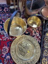 A brass fire iron set, bed warmer, two brass pots, a brass scuttle, two leather brasses, and three