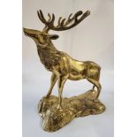 A brass model of a stag on a naturalistic plinth. 38cm x 28 cm.