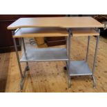 A laminated wood and metal frame desk with two lower sliding shelves and rear castor wheels. 75cm