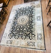 A large cream and black ground rug, with central medallion on elaborate decoration, bordered and