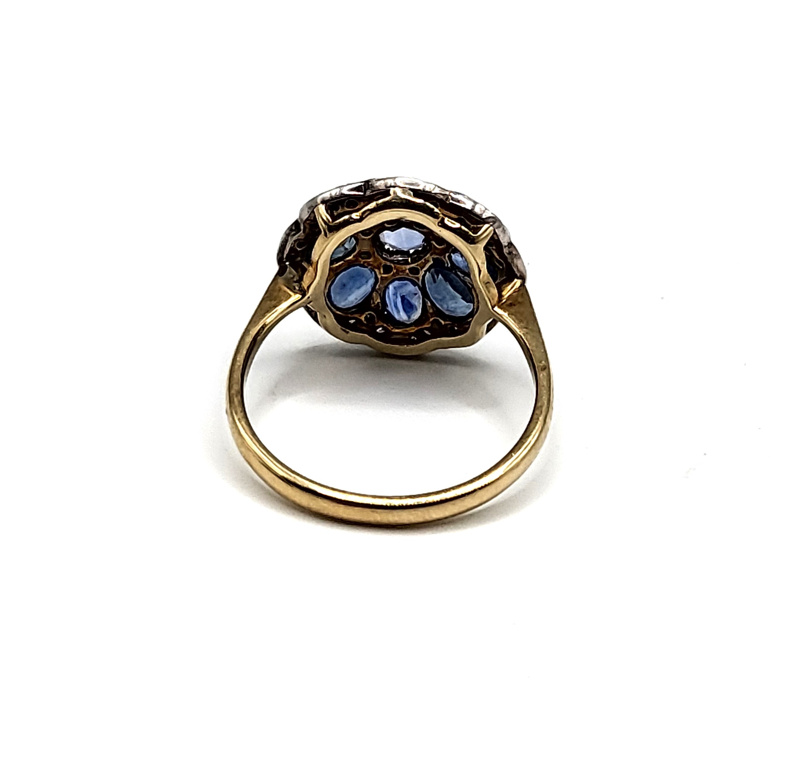A yellow metal, sapphire, and diamond daisy cluster ring, the silver mount inset with mixed oval and - Image 3 of 3