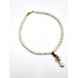 A freshwater pearl necklace, suspended with an amethyst and pearl drop pendant, gilt metal clasp.