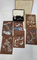 Two silver spoons, boxed, James Dixon & Sons, 1927, and six Japanese stencils.