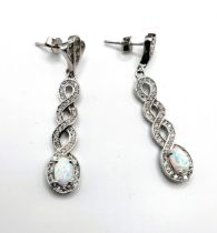 A pair of silver cubic zirconia and opalite drop earrings