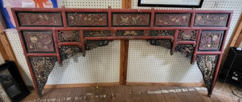 An unusual 20th century Chinese carved wood headboard, the red painted screen set with panels