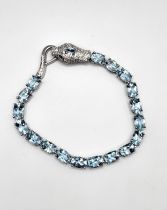 A silver aquamarine bracelet with snake head clasp. Approx 17cm.