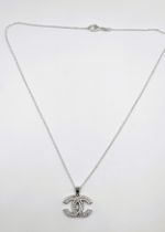 A silver and cubic zirconia designer style pendant necklace. Pendant approx. 2cm x 2.5cm