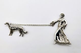 A silver Art Deco style lady (approx 5cm x 3cm) walking her dog brooch (approx 2.5cm x 3.5cm)