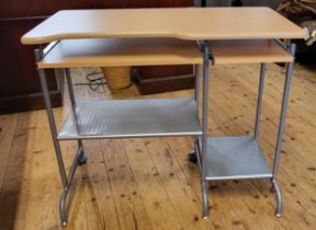 A laminated wood and metal frame desk with two lower sliding shelves and rear castor wheels. 75cm