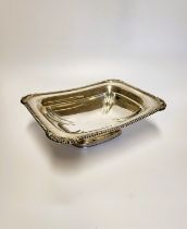 A silver bread basket / dish, with gadrooned rim and shell corners, hallmarked London 1904, makers
