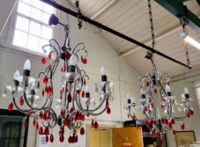 An unusual pair of eight branch glass chandeliers with red and clear glass droplets. 94cm x 68cm.
