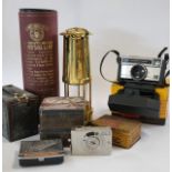 A collection of metalware items including an oil lamp and tins, together with a camera (Brownie) and