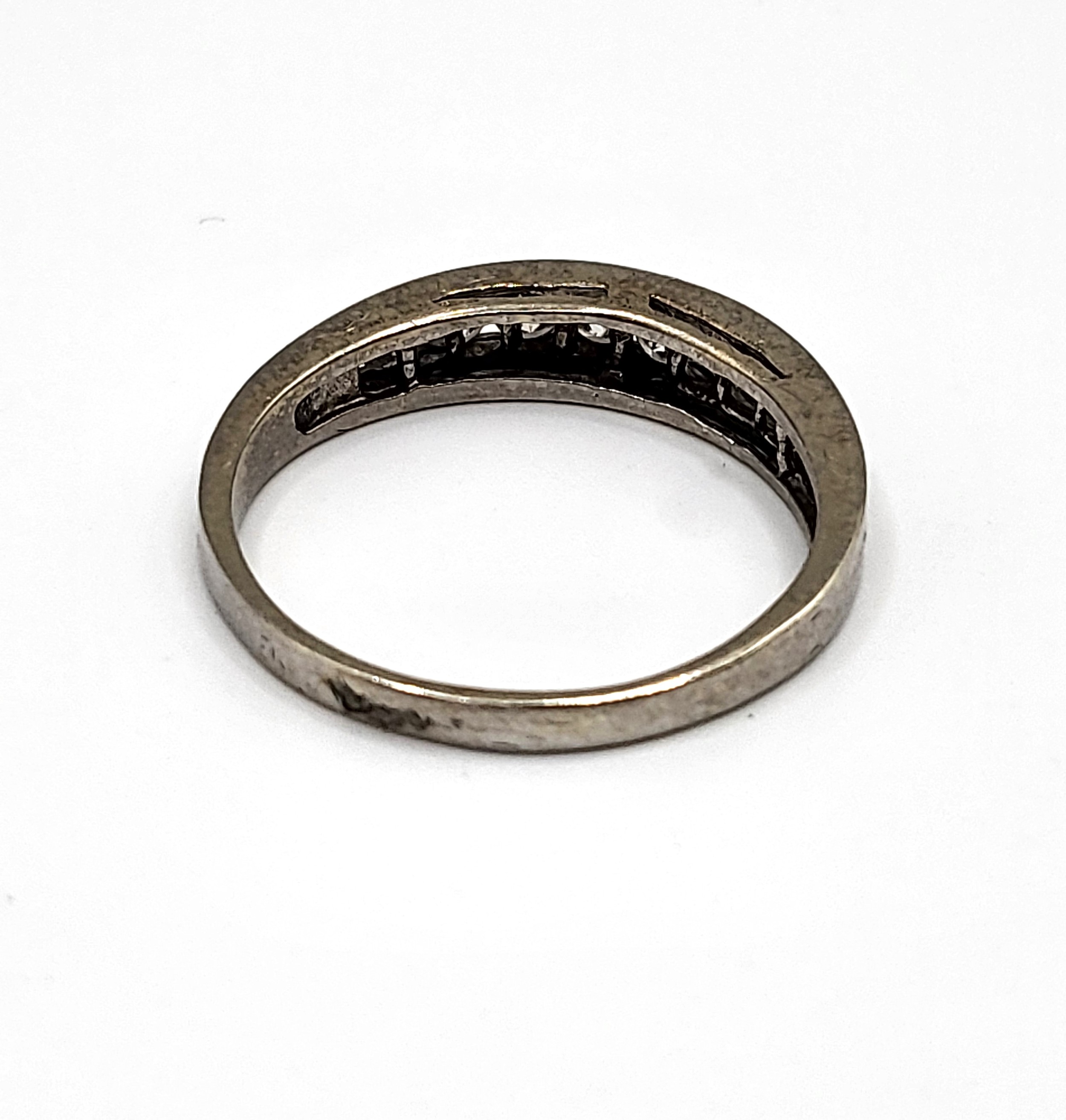 A white gold diamond half eternity ring, channel set with round ...