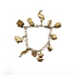 A 9ct yellow gold charm bracelet, suspended with 9ct charms including baby shoes, a stork, a rabbit,
