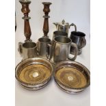 A group of silver plated items, including tankards, a bottle coaster, candlesticks, a coffee pot,