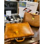 A leather suitcase and bag foot circ. and camera accessories