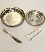 A silver strawberry dish, a silver butter dish, tongs, and butter knife.