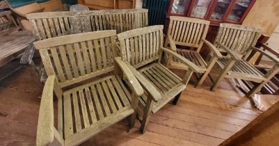 A wooden garden bench 162cm (w), together with four matching chairs.