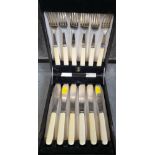 A set of six plated knives and forks, with cream coloured handles, in fitted case.
