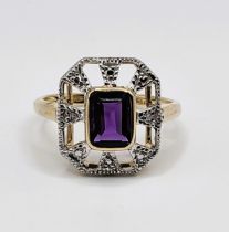 A 9ct yellow gold amethyst dress ring, set with a mixed rectangular-cut amethyst, within an openwork