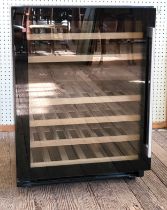 An Amica wine fridge with six shelves. 84cm x 60cm x 57cm.
