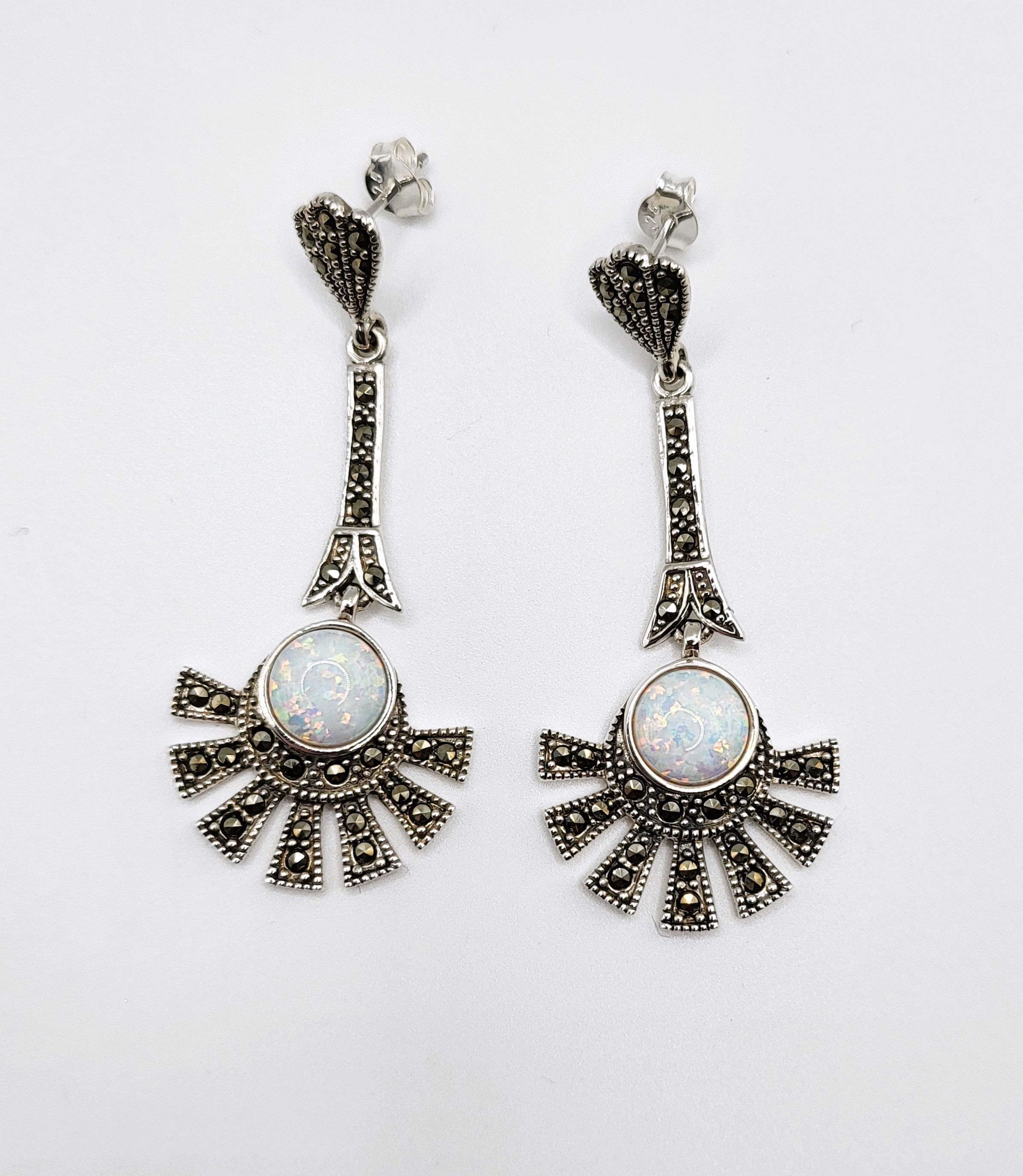 A pair of silver cubic circonia and marcasite fan shaped earrings with opalite panels