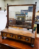 A wooden framed vanity mirror, supported on stand with two drawers.