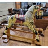 A large painted wooden rocking horse. 126cm x 150cm.