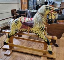 A large painted wooden rocking horse. 126cm x 150cm.
