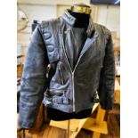 1970 motorcycling clothing including a Skin brand, size medium leather jacket (well worn), a pair of
