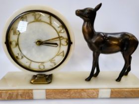 An Art Deco clock with a bronze fawn, on a marble plinth.