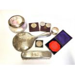 A silver backed hand mirror, together with a silver backed brush, a silver mounted glass powder jar,